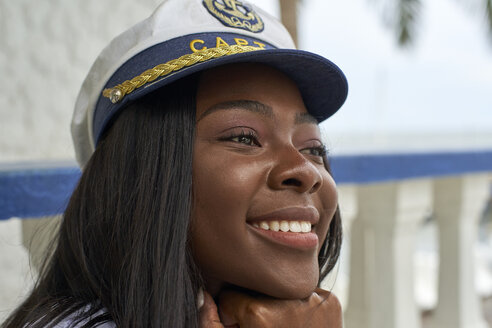 Portrait of happy young woman wearing Captain's hat - VEGF00086