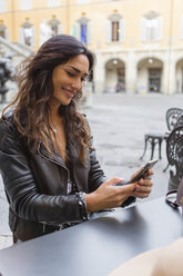 Young woman with cup of coffee, using smartphone - MGIF00398