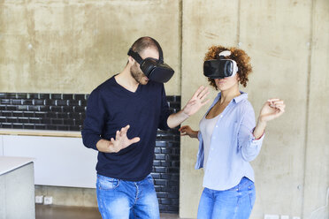 Man and woman wearing VR glasses moving - FMKF05623