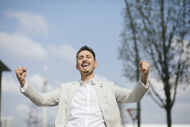 Portrait of businessman, clenching fist - KMKF00860