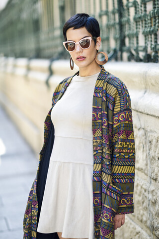 Portrait of confident fashionable young woman outdoors stock photo