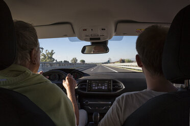 Italy, Sicily, two men in car on the highway - MAMF00591