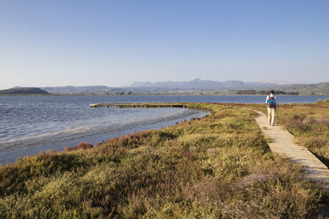 Greece, Messenia, Gialova Lagoon, hiker on the nature trail - MAMF00597