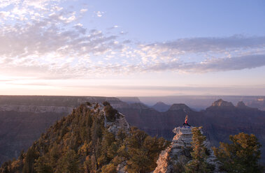 Caucasian woman practicing yoga on top of rock formation - BLEF00163