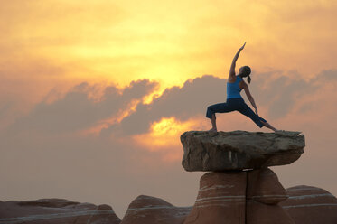 Caucasian woman practicing yoga on top of rock formation - BLEF00168