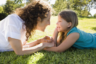 Mother and daughter laying in grass together - BLEF00177