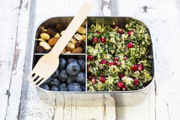 Lunchbox with bulgur herbs salad with pomegranate seeds, taboule, blueberries and trail mIx - LVF07973