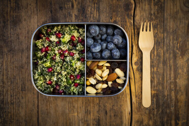 Lunchbox with bulgur herbs salad with pomegranate seeds, taboule, blueberries and trail mIx - LVF07974