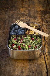 Lunchbox with bulgur herbs salad with pomegranate seeds, taboule, blueberries and trail mIx - LVF07975