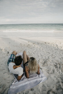 Mexico, Quintana Roo, Tulum, couple lying on the beach looking at view - LHPF00681