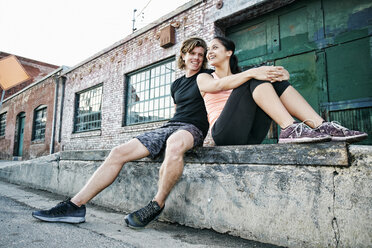 Couple resting on loading dock - BLEF00333