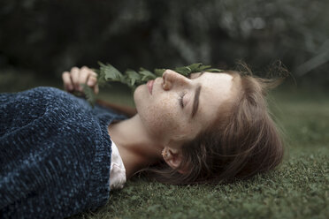 Caucasian girl with freckles laying in grass - BLEF00421