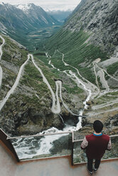 Caucasian man standing at viewpoint admiring scenic view of valley - BLEF00556