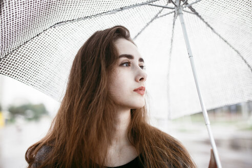 Caucasian woman holding white umbrella - BLEF00564