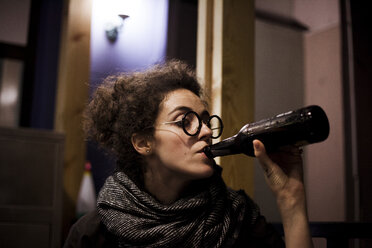 Caucasian woman drinking bottle of beer - BLEF00625
