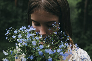 Caucasian woman smelling flowers - BLEF00745