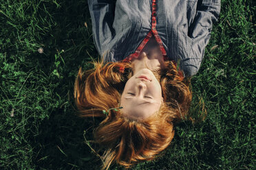 Caucasian teenage girl laying in grass - BLEF00751