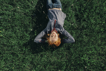 Caucasian teenage girl laying in grass - BLEF00752