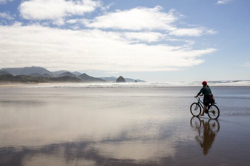 Caucasian woman riding bicycle on beach - BLEF00774