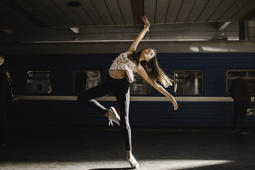 Caucasian woman dancing near train - BLEF00938