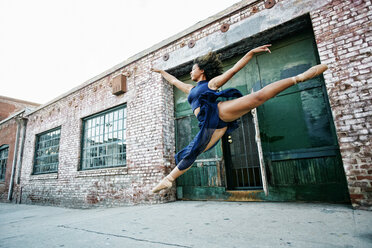 Mixed race woman dancing ballet in city - BLEF00962