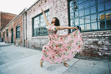 Mixed race ballet dancer wearing dress on sidewalk - BLEF00964