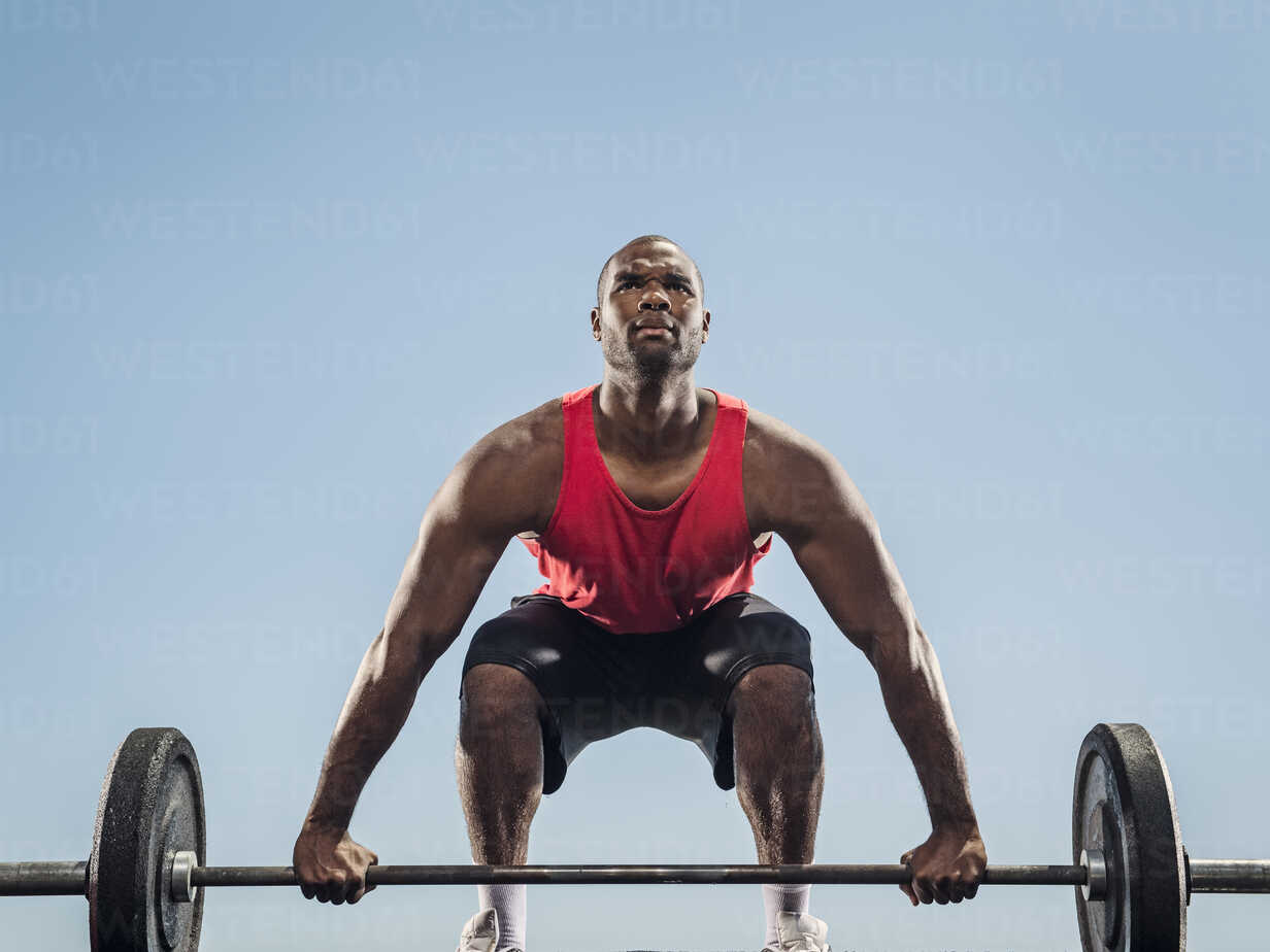 Strong adult black African men lift barbell to do crossfit