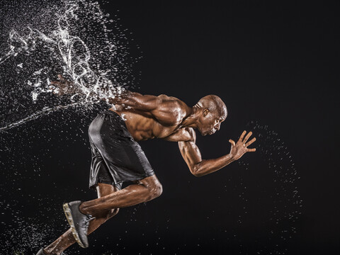 Water splashing on black runner stock photo