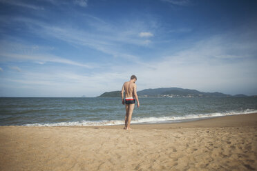 Pensive Caucasian man standing on beach - BLEF01080