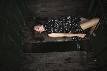 Kaukasische Frau liegt auf einer Holzbrücke - BLEF01164