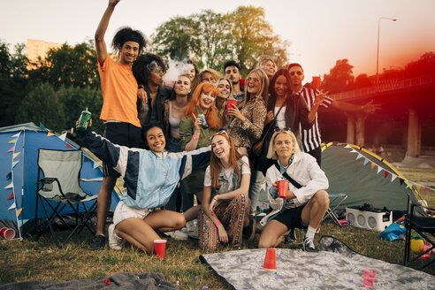 Porträt von glücklichen Freunden beim Zelten während einer Musikveranstaltung - MASF12048