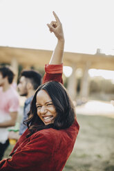 Portrait of cheerful woman dancing at music event during summer - MASF12082