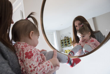 Reflection of Caucasian mother and baby daughter in mirror - BLEF01208