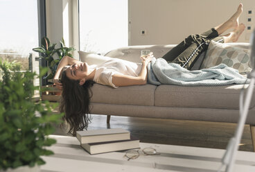 Relaxed young woman lying on couch - UUF17256