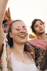Man and woman cheering while enjoying music festival - MASF12163