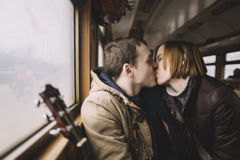 Caucasian couple kissing on train - BLEF01255