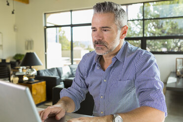 Caucasian man using laptop on table - BLEF01307