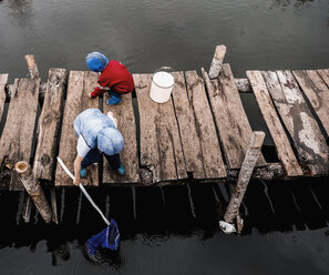 Boys playing on wooden dock - BLEF01604