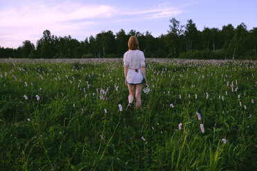 Woman walking in field - BLEF01611