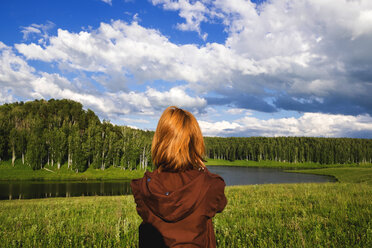 Woman admiring scenic view of river - BLEF01616