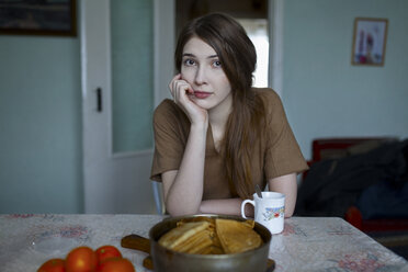 Pensive Caucasian woman sitting at table - BLEF01692