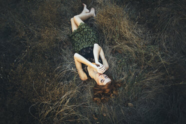 Pensive Caucasian woman laying on grass - BLEF01715