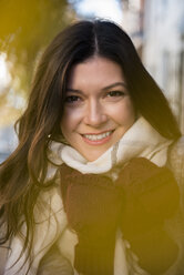 Smiling Caucasian woman wearing gloves and scarf - BLEF01801