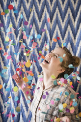 Happy woman celebrating with confetti - BLEF01837