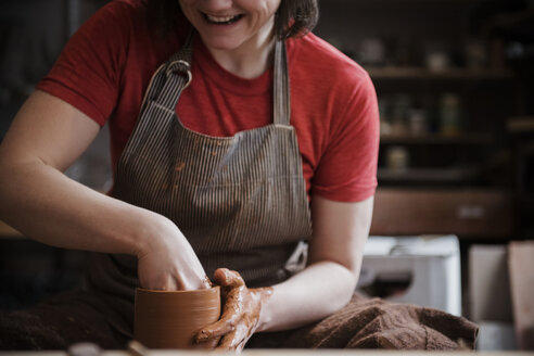 Caucasian woman shaping pottery clay - BLEF01870