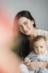 Portrait of Caucasian mother holding son in lap - BLEF01919