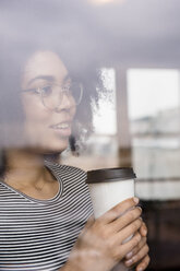 Pensive African American woman drinking coffee behind window - BLEF01940