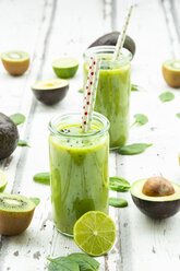 Two glasses of green smoothie with avocado, spinach, kiwi and lime - LVF07995