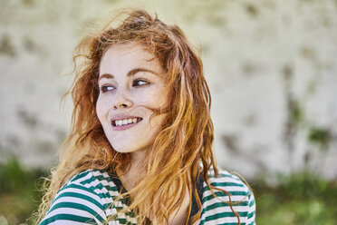 Portrait of redheaded young woman with freckles - FMKF05666