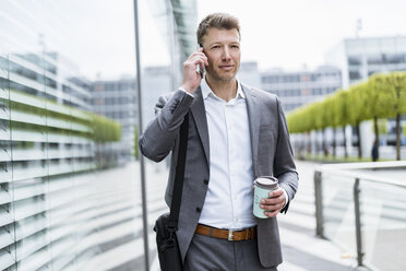 Businessman on cell phone on the move in the city - DIGF06859